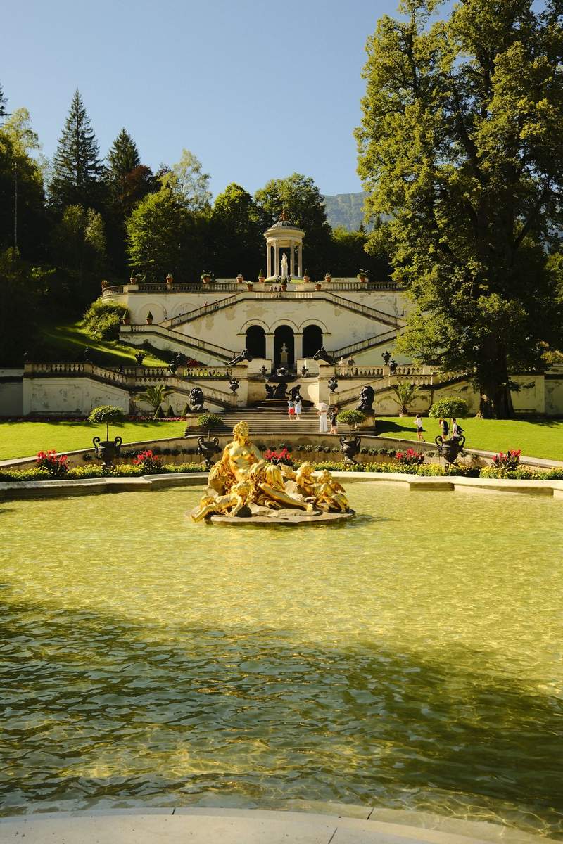 A gilded statue group above a fountain basin at Linderhof.